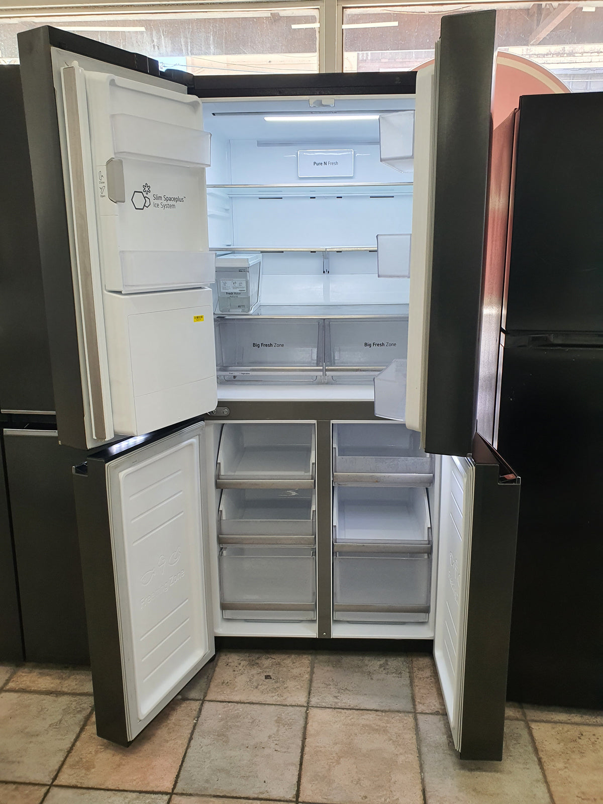 LG French Door 570 L Fridge Freezer in a Matte Black finish, featuring an integrated ice and water dispenser Cheap World Online